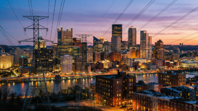 Pennsylvania city skyline at dusk with power lines.